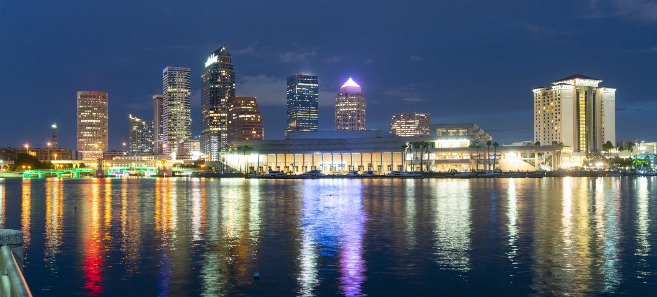 Panoramic Tampa skyline glowing over the bay at night